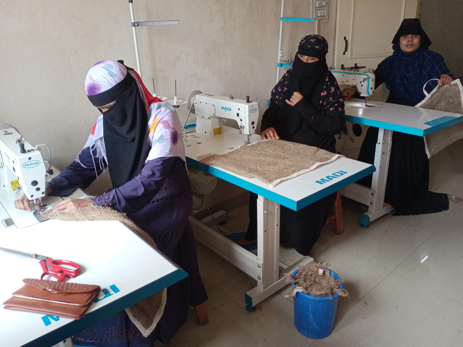 Women learning tailoring skills